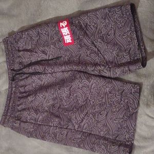 Encrypted medium grey shorts with black tidal wave pattern
